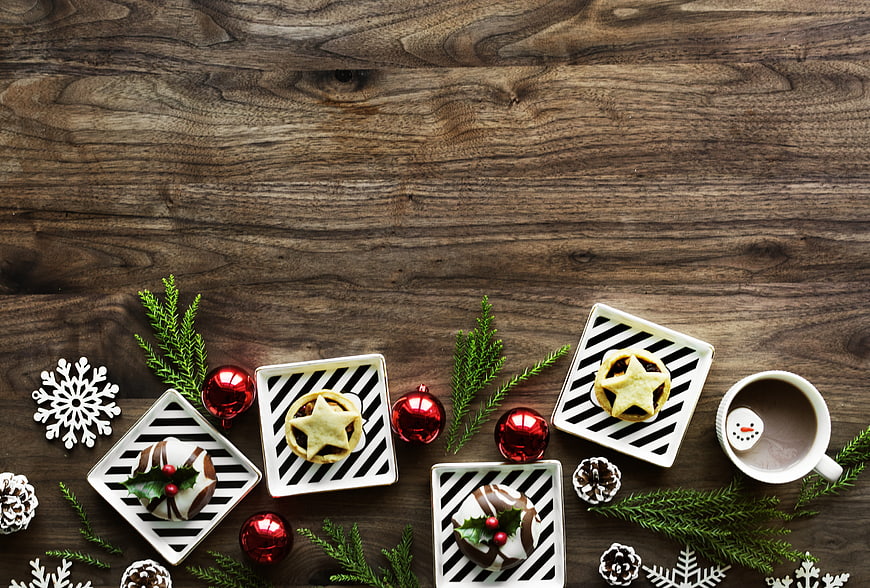 Christmas desserts and hot chocolate on rustic wooden background