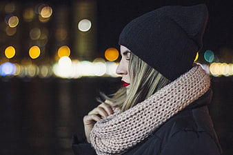 Woman in Beanie and Scarf with City Bokeh Lights
