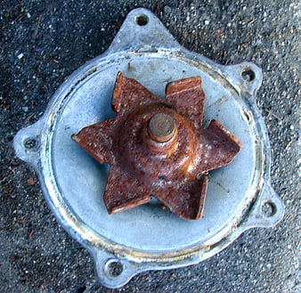 Rusted metal impeller on silver housing top view