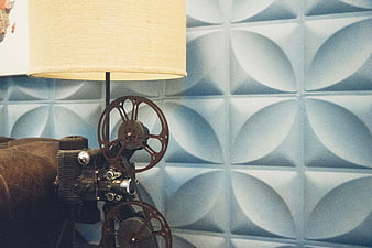 Vintage Film Projector Lamp with Textured Blue Wall Background