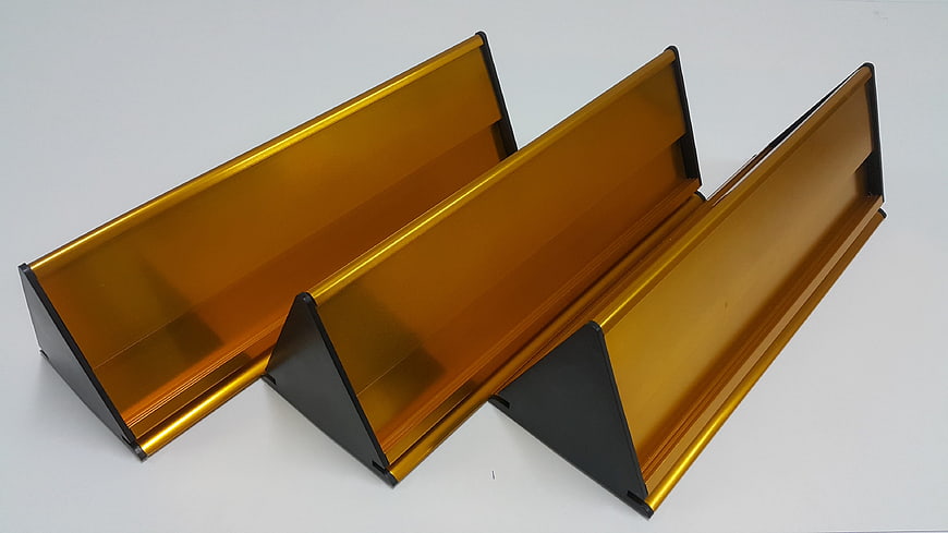 Three amber acrylic display stands with black bases