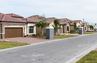 New suburban homes under construction with portable toilets