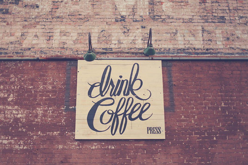 Drink Coffee Typography Sign on Vintage Brick Wall