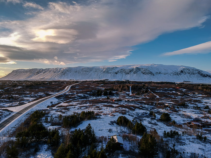 Aerial View of Snowy Mountain Landscape with Winding Road