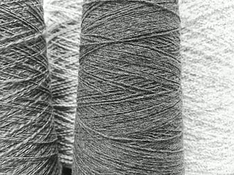 Close-up of grey wool yarn texture on spools