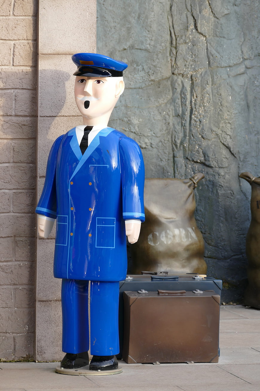 Blue Railway Conductor Statue with Luggage