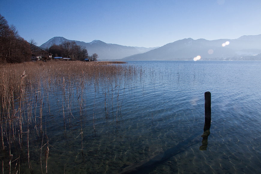 Winter Lake Landscape With Distant Mountains And Reeds
