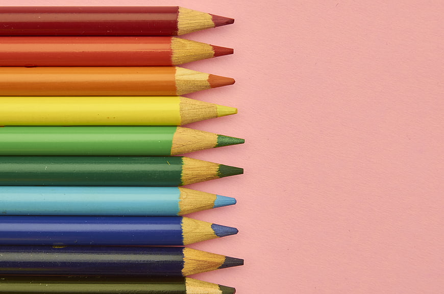 Colorful Pencils Arranged on Pink Background
