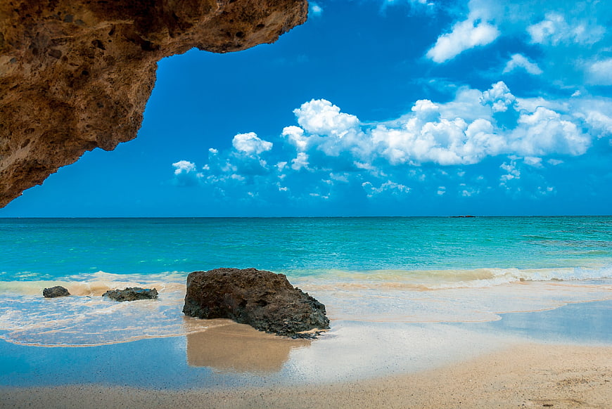 Tropical Beach Landscape With Rock Overhang And Turquoise Sea