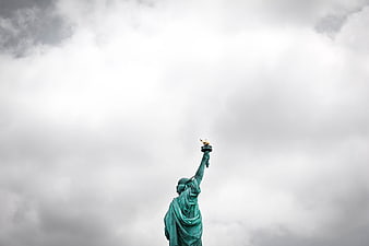 Statue of Liberty Torch Against Cloudy Sky