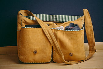 Mustard Suede Satchel with Green Striped Lining on Wood