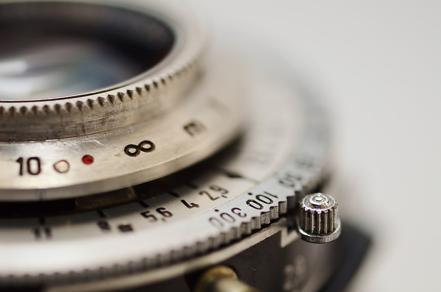 Close-up of vintage camera lens with infinity focus symbol