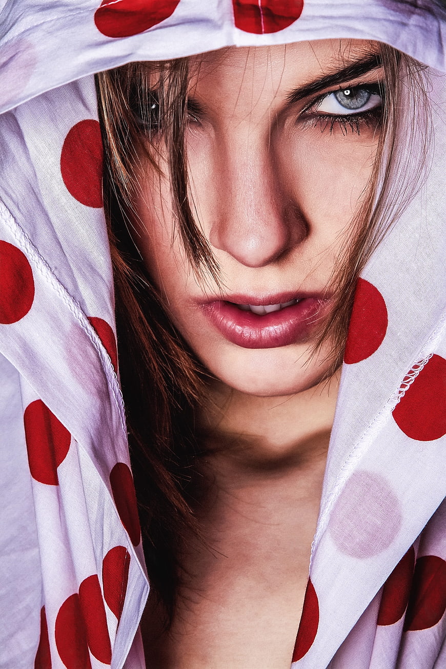 Intense Close-Up Portrait of Woman in Polka Dot Hood