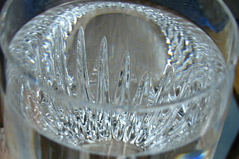 Close-up of textured clear glass with light refraction