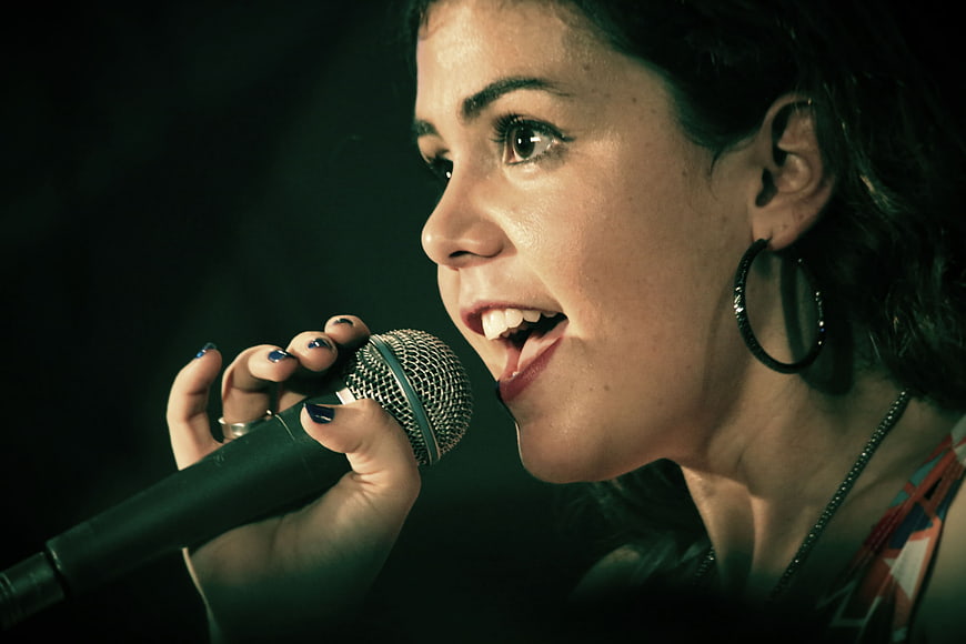 Close-up of a female singer performing with a microphone