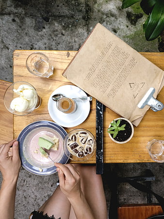 Top view of iced coffee and matcha cake on wooden table
