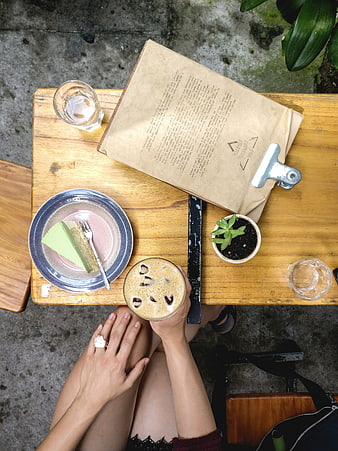 Top view of iced coffee and matcha cake on wooden table