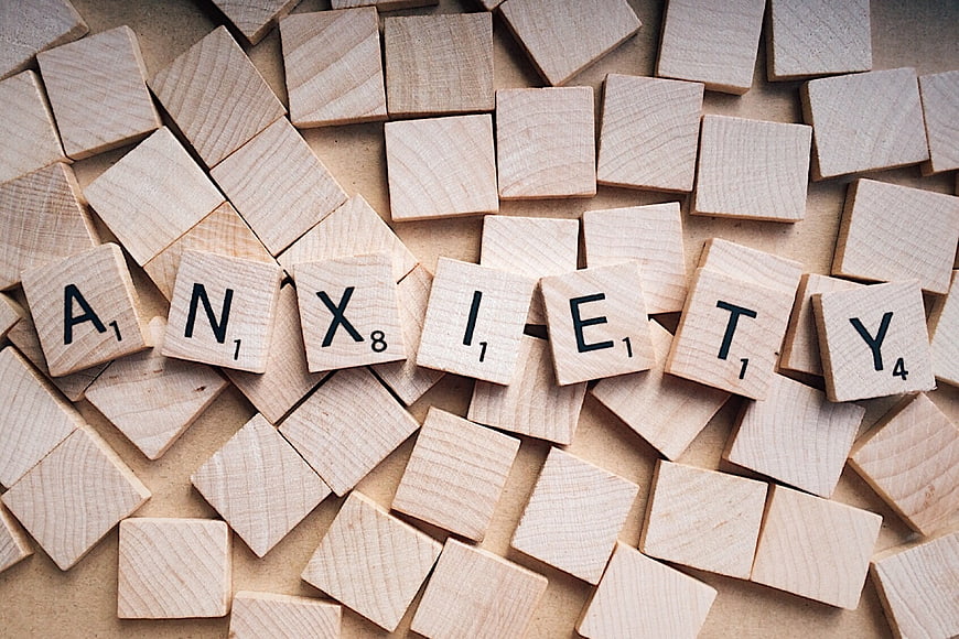 Wooden Scrabble Tiles Spelling Anxiety on Table