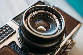 Close-up of vintage Fujifilm camera lens with shallow depth of field