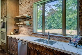 Modern Rustic Kitchen Interior With Exposed Brick Wall And Marble Countertop