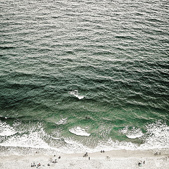Aerial View of Green Ocean Waves Crashing on Sandy Beach