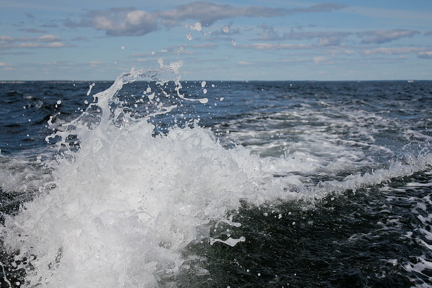 Dynamic Sea Water Splash Against Blue Sky Background