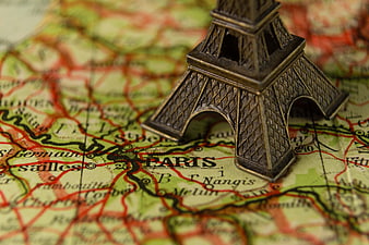 Miniature Eiffel Tower Model on Vintage Paris Map