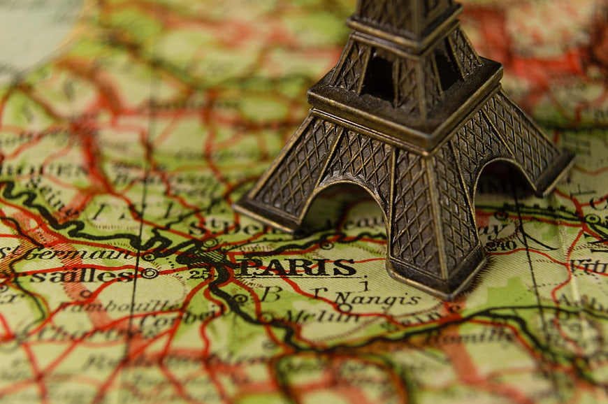 Miniature Eiffel Tower Model on Vintage Paris Map