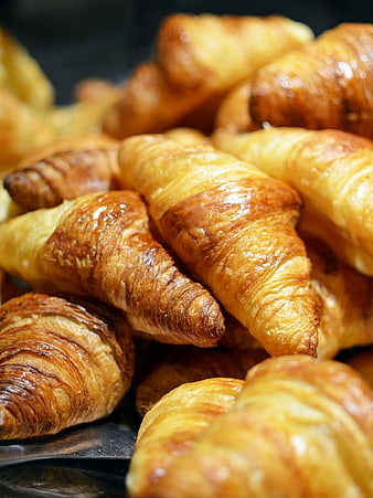 Close-up of golden flaky croissants in a bakery