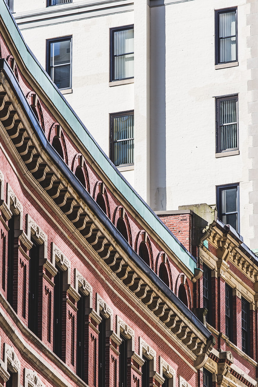 Ornate red brick building facade with white modern architecture background