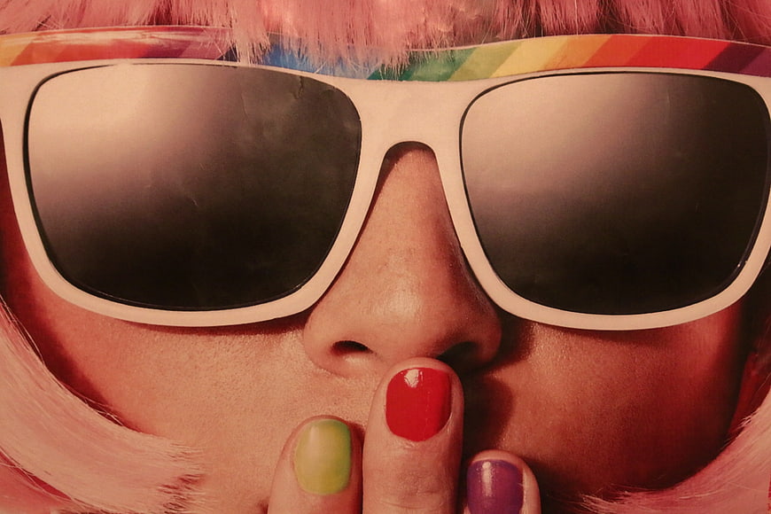 Close-up of woman with pink hair and colorful nails
