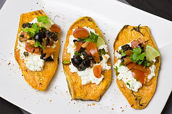 Roasted Sweet Potato Boats Topped With Olives, Tomatoes, And Sour Cream