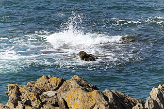 Ocean waves crashing against rocky coastal cliffs