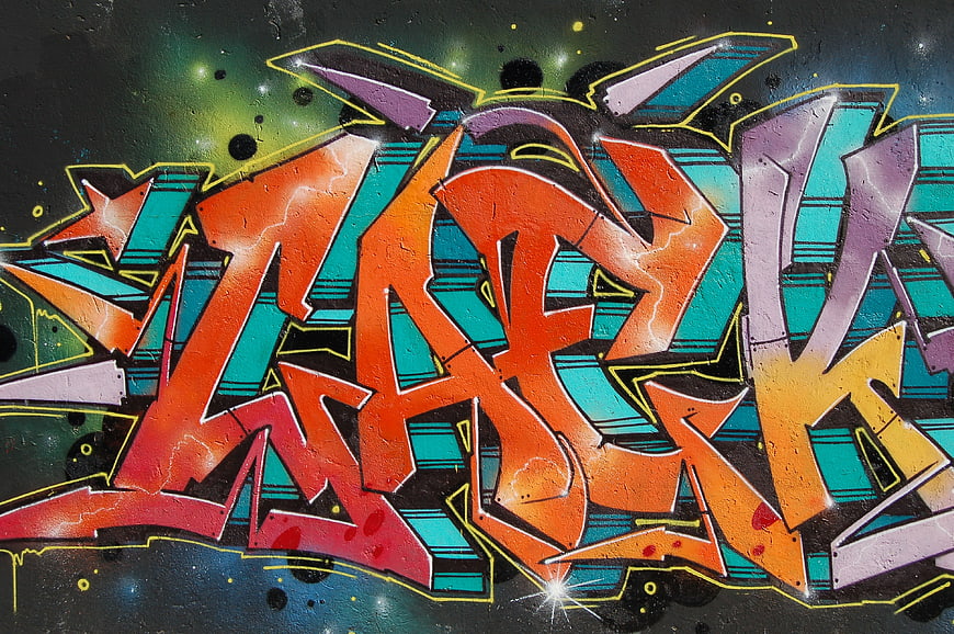 Colorful graffiti mural with vibrant orange and teal lettering