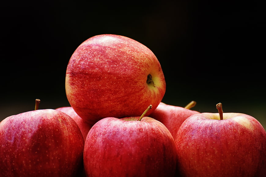 Close-up of fresh red apples on dark background