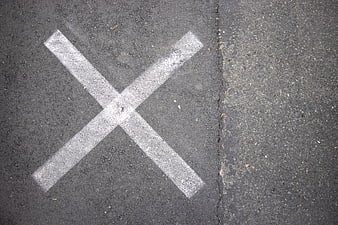 White X Mark Painted on Asphalt Road Surface