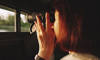 Woman Looking Through Binoculars Out of Train Window