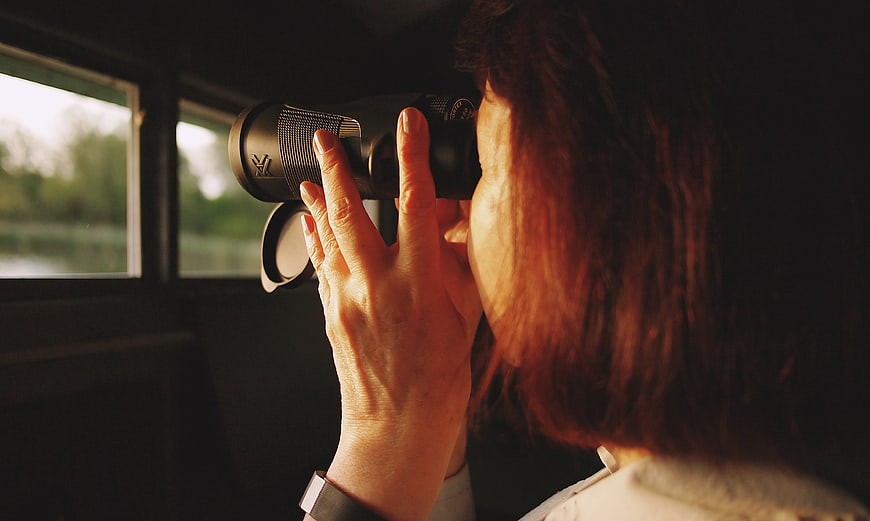 Woman Looking Through Binoculars Out of Train Window