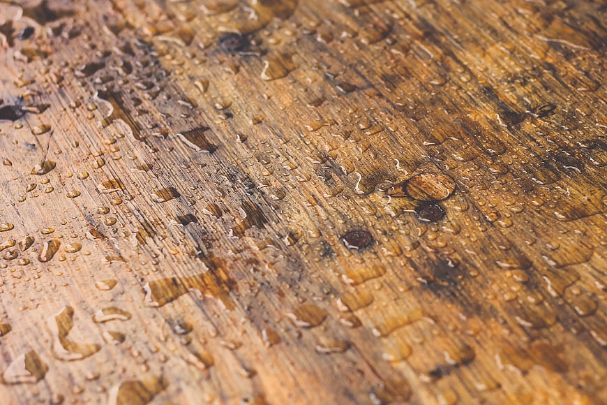 Close-up of wet wooden texture with water droplets
