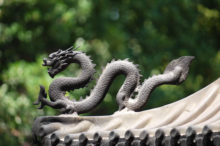 Gray Dragon Statue on Traditional Roof