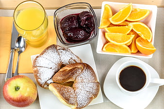 Healthy breakfast with coffee, juice, fruit, and pastries
