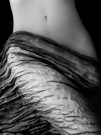 Black and White Close Up of Female Belly and Draped Fabric