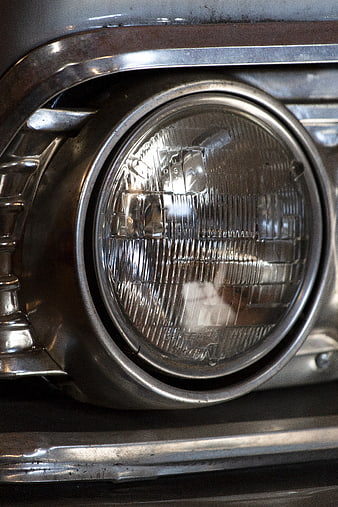 Close-up of vintage car headlight with chrome details