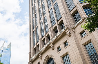 Low angle view of beige stone office building facade