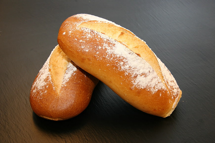 Two Freshly Baked Baguettes on Dark Slate Background