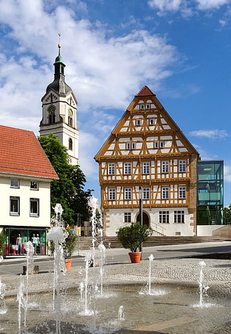 Traditional half-timbered building and church tower in Neuhausen-Fildern