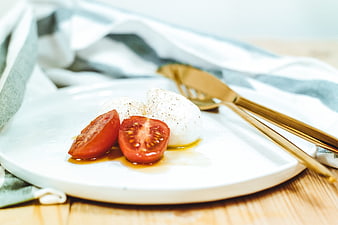 Fresh Caprese Salad with Mozzarella and Tomatoes on White Plate