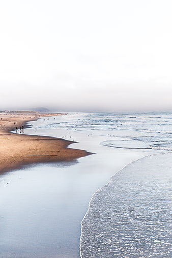 Serene Beach Landscape with Gentle Waves and Sandy Shore