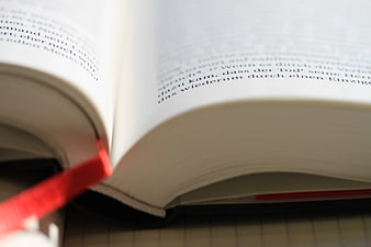 Close-up of Open Book with German Text and Red Bookmark