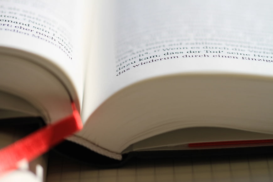 Close-up of Open Book with German Text and Red Bookmark